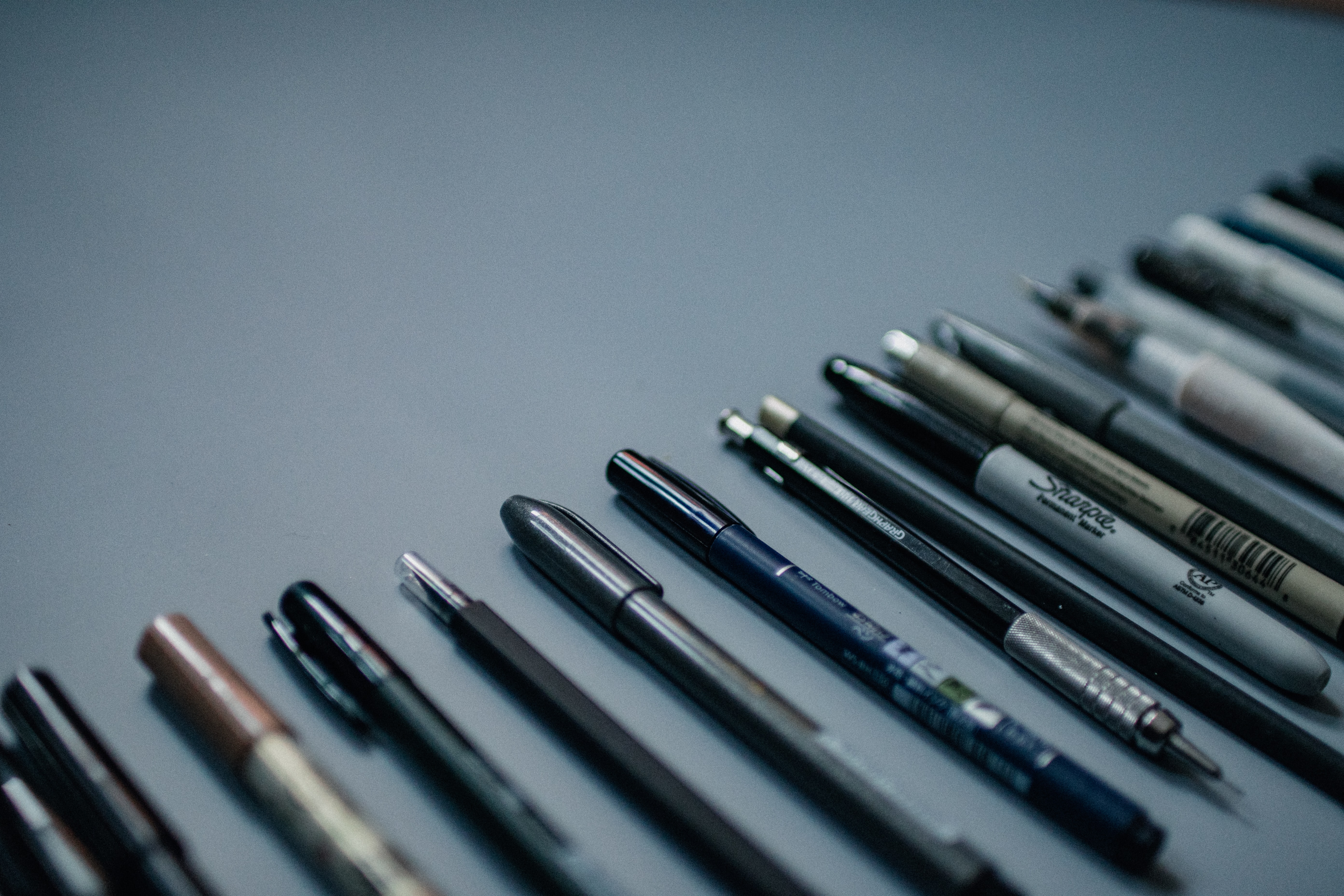 Pens and pencils arranged around an open writing space
